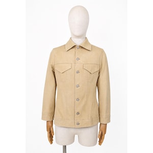 May include: A beige jacket with a traditional collar, two chest pockets, and button fastenings. The jacket is displayed on a mannequin. The jacket has long sleeves and a tailored fit, suitable for casual or semi-formal wear.