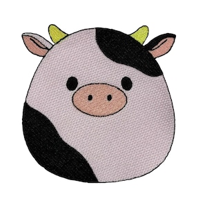 May include: A white and black embroidered patch of a cartoon cow with yellow horns and a pink nose.