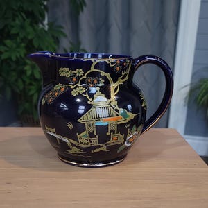 Bursley Ware Crown Pottery presents a Cobalt Squat Pitcher featuring a Pagoda, crafted in Burslem, England.