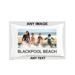 May include: A white pillowcase with a photo of a family of four splashing in a pool. The text "Blackpool Beach" is printed below the photo. The text "ANY IMAGE" is printed above the photo and "ANY TEXT" is printed below the text.