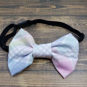 May include: A pastel plaid bow tie with an elastic band.