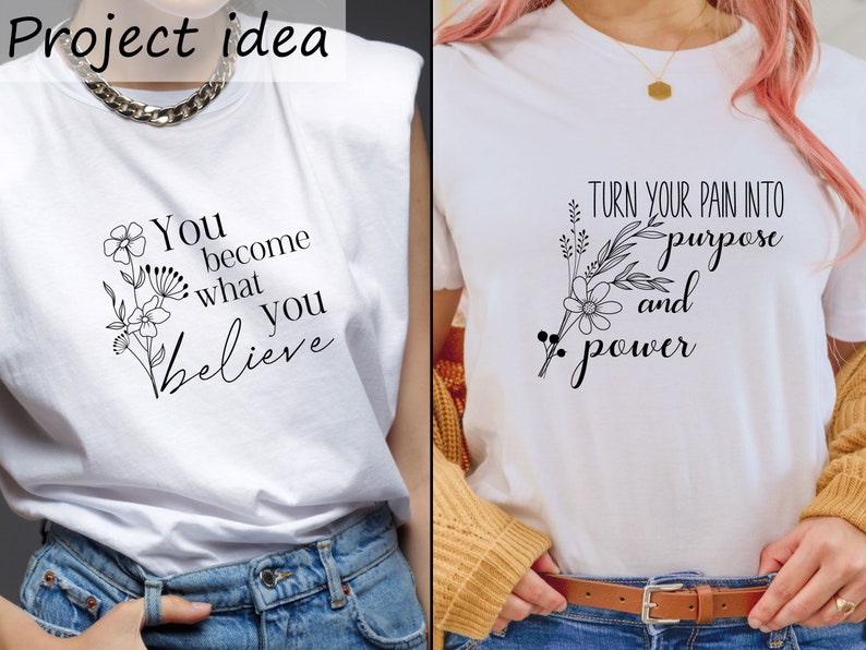 May include: Two white t-shirts with black text and floral designs. The first shirt says "You become what you believe" and the second shirt says "Turn your pain into purpose and power".