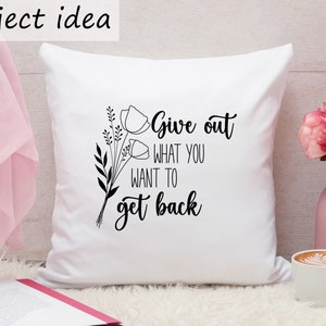 May include: White throw pillow with black text and floral design. The text reads "Give out what you want to get back."