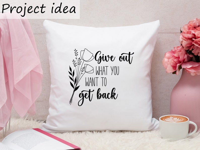 May include: White throw pillow with black text and floral design. The text reads "Give out what you want to get back."