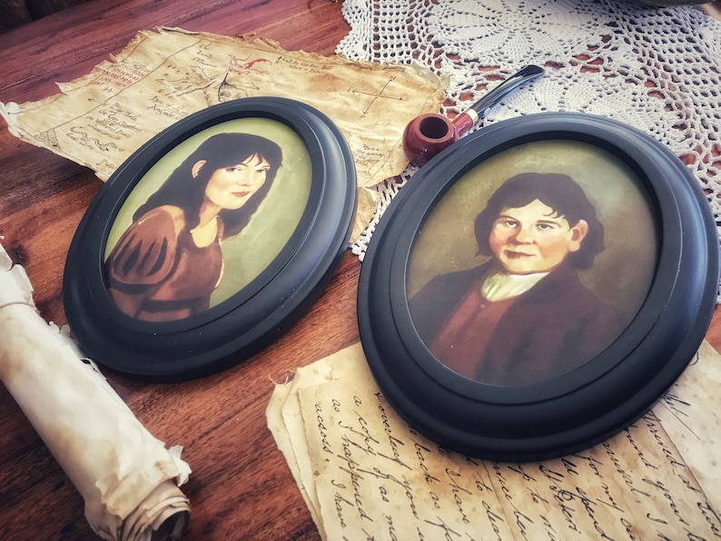 May include: Two oval framed portraits with black frames. The portraits depict individuals with dark hair and are set against a green background. A pipe, aged paper, and a rolled scroll are also visible, suggesting a vintage theme.