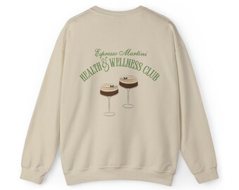 May include: A beige sweatshirt with the text "Espresso Martini Health & Wellness Club" in green lettering and a graphic of two espresso martinis.