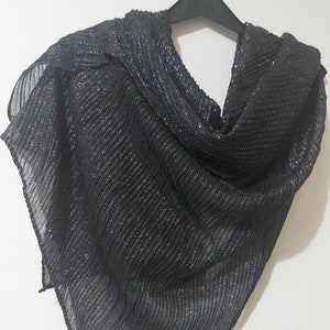 May include: A black sparkly sheer scarf with a crinkled texture.