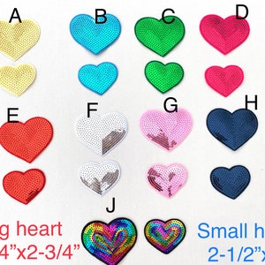 May include: Assortment of 10 heart-shaped sequins in various colors, including yellow, blue, green, red, white, pink, and navy blue. The sequins are arranged in two rows of five, with the larger sequins on top and the smaller sequins on the bottom. The larger sequins are 3-1/4 inches by 2-3/4 inches, and the smaller sequins are 2-1/2 inches by 2 inches. The sequins are labeled with letters A through J.
