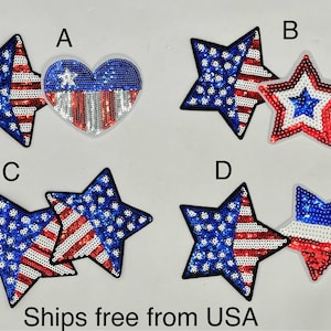 May include: Four different styles of iron-on patches featuring the American flag in red, white, and blue sequins. The patches are shaped like stars and hearts.