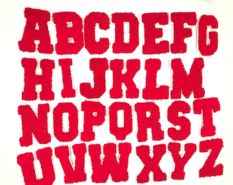 May include: Red felt alphabet letters, A through Z, in a block font style. The letters are individually cut out and arranged in alphabetical order.