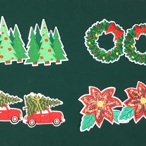 May include: A set of Christmas-themed iron-on patches. The set includes two wreaths with red bows, two poinsettia flowers, two Christmas trees, and two red cars with Christmas trees on top.