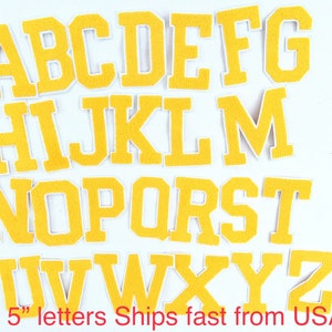 May include: A set of 26 yellow felt letters, each measuring 5 inches tall. The letters are in uppercase and are arranged in alphabetical order. The letters are on a white background.