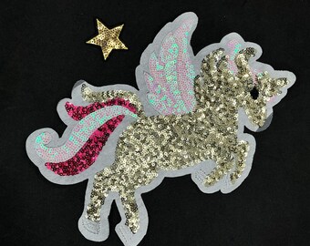 May include: A gold sequined unicorn with pink and blue wings and a pink and blue tail. The unicorn is on a white background with a gold star.