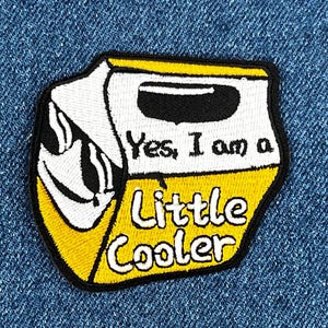 May include: Yellow and white embroidered patch shaped like a mini cooler with the text "Yes, I am a Little Cooler".
