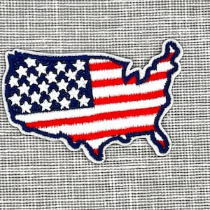 May include: An embroidered patch shaped like the United States of America with the American flag design in red, white, and blue.
