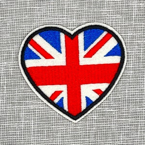 May include: A heart-shaped patch with the Union Jack flag embroidered on it. The patch is red, white, and blue.