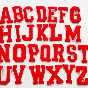 May include: Red felt alphabet letters with white outlines. The letters are in uppercase and are arranged in alphabetical order.