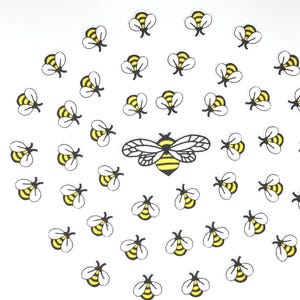 May include: A white background with a pattern of yellow and black bees. The bees are all facing different directions and are scattered randomly across the background.