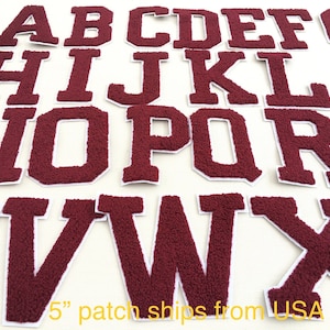 May include: A set of 26 burgundy felt letters, each measuring 5 inches tall, representing the English alphabet. The letters are individually cut out and have a white outline.