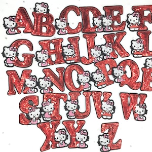 May include: Red felt alphabet letters with a cartoon character design. Each letter is decorated with a small, pink Hello Kitty-like character.