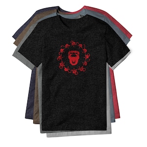May include: A stack of short-sleeved t-shirts in various heathered colors including black, gray, blue, brown, and red. The top black shirt features a central red graphic of a roaring gorilla face surrounded by a circular pattern of small monkeys.