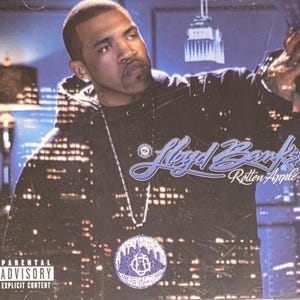 May include: CD case featuring a man in a black hoodie with a city skyline backdrop. The album title "Rotten Apple" is in a stylized font. The Parental Advisory Explicit Content warning is visible.