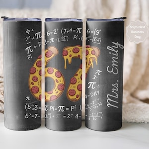 May include: A black tumbler with a chalkboard design. The number "67" is designed with pizza slices. Mathematical equations and the name "Mrs. Emily" are written in white. The tumbler has a black lid.