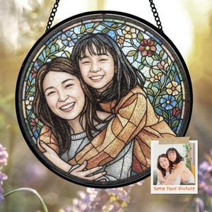 May include: Round stained glass art piece featuring a portrait of two smiling people embracing. The artwork is framed in black and includes floral and geometric patterns in various colors. A small photo with the text "Send Your Picture" is attached.