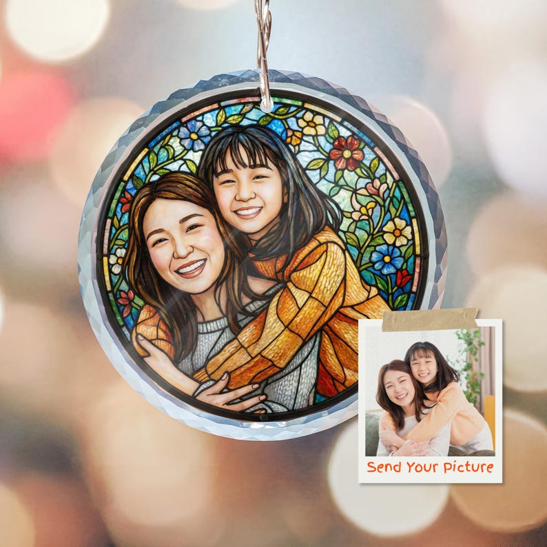 May include: A round, clear crystal ornament with a stained-glass style design. The design features a portrait of two smiling people, surrounded by colorful flowers. A small photo with the text "Send Your Picture" is attached.