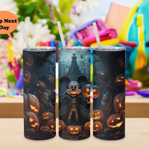May include: Three black and white stainless steel tumblers with a Halloween theme. The tumblers feature a Mickey Mouse character dressed as a vampire, surrounded by pumpkins and other Halloween imagery.