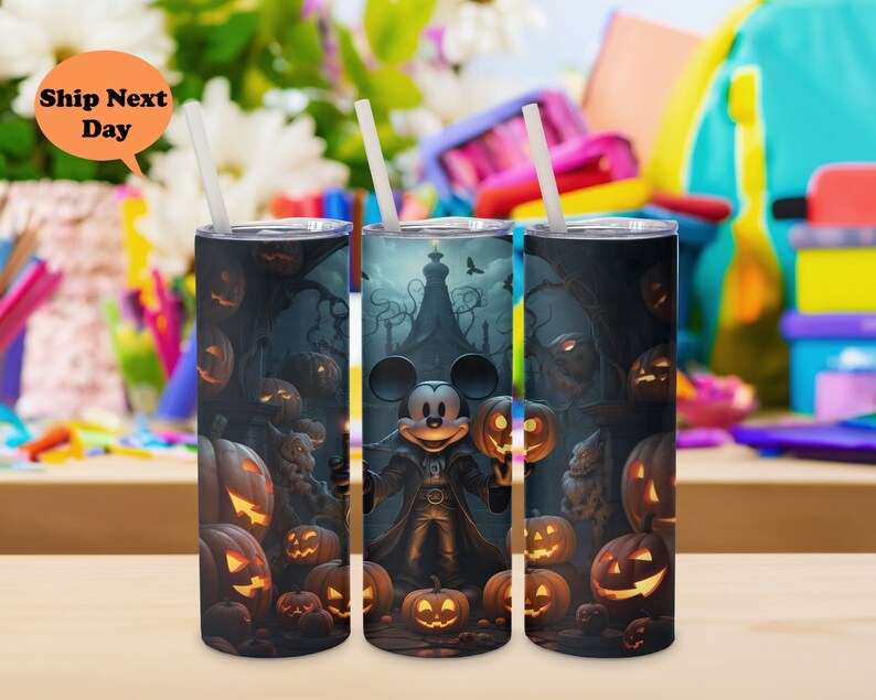 May include: Three black and white stainless steel tumblers with a Halloween theme. The tumblers feature a Mickey Mouse character dressed as a vampire, surrounded by pumpkins and other Halloween imagery.