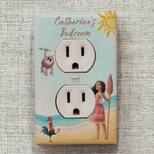 May include: A rectangular light switch wall plate featuring a light blue and sandy beach background with a sun graphic, a cartoon coconut character, a rooster, and a female character holding a wooden paddle, with the text Catherine's Bedroom.
