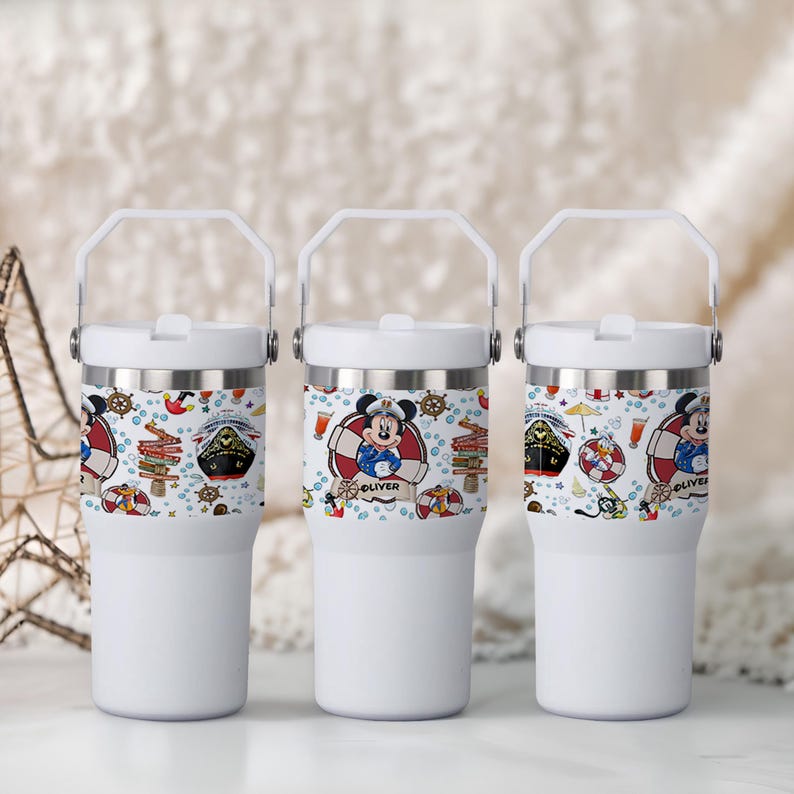 May include: Three white insulated tumblers with a white handle and lid. Each tumbler features a nautical-themed design with Mickey Mouse in a life preserver, a ship, and the name "Oliver".