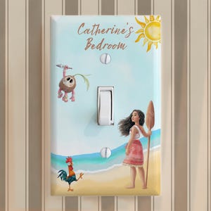 May include: A rectangular light switch plate featuring a beach scene with a cartoon girl holding a wooden paddle, a small rooster, and a coconut creature. The text "Catherine's Bedroom" is printed at the top with a yellow sun illustration.