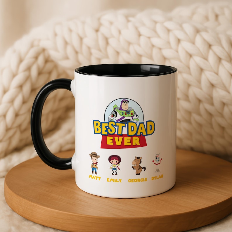 May include: A white ceramic mug with a black handle and interior rim. The front features a graphic of Buzz Lightyear above the text BEST DAD EVER. Below are four cartoon characters with the names Matt, Emily, Georgie, and Dylan printed underneath.