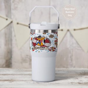 May include: White insulated tumbler with a handle and a decorative wrap featuring a cartoon dog in a sailor outfit, life preservers, and nautical elements. The name "Oliver" is displayed on the wrap.