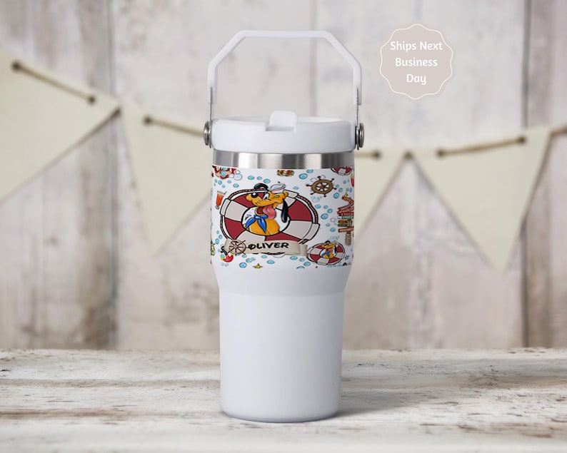 May include: White insulated tumbler with a handle and a decorative wrap featuring a cartoon dog in a sailor outfit, life preservers, and nautical elements. The name "Oliver" is displayed on the wrap.
