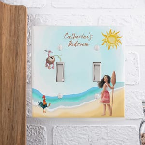 May include: A double light switch plate featuring a beach scene with a yellow sun, a cartoon coconut character, a rooster, and a girl holding a wooden oar. The text Catherine's Bedroom is printed in brown script at the top of the white plastic cover.