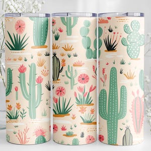 May include: Three cylindrical tumblers featuring a repeating pattern of various green cacti and pink desert flowers on a light peach background. Each tumbler has a flat metallic lid and a smooth, straight-sided design with a consistent print.