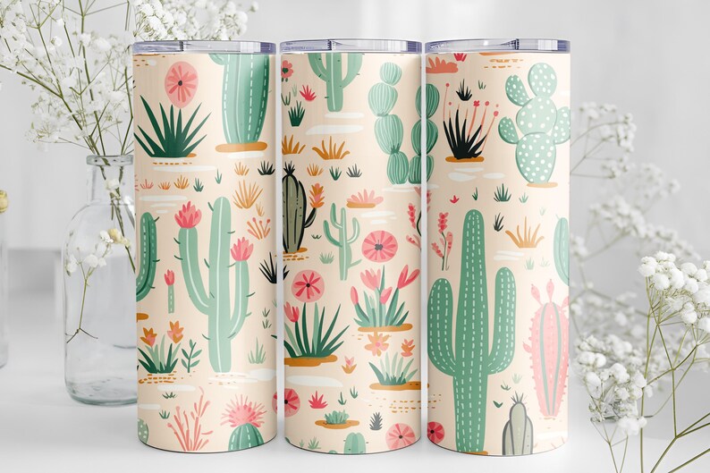 May include: Three cylindrical tumblers featuring a repeating pattern of various green cacti and pink desert flowers on a light peach background. Each tumbler has a flat metallic lid and a smooth, straight-sided design with a consistent print.