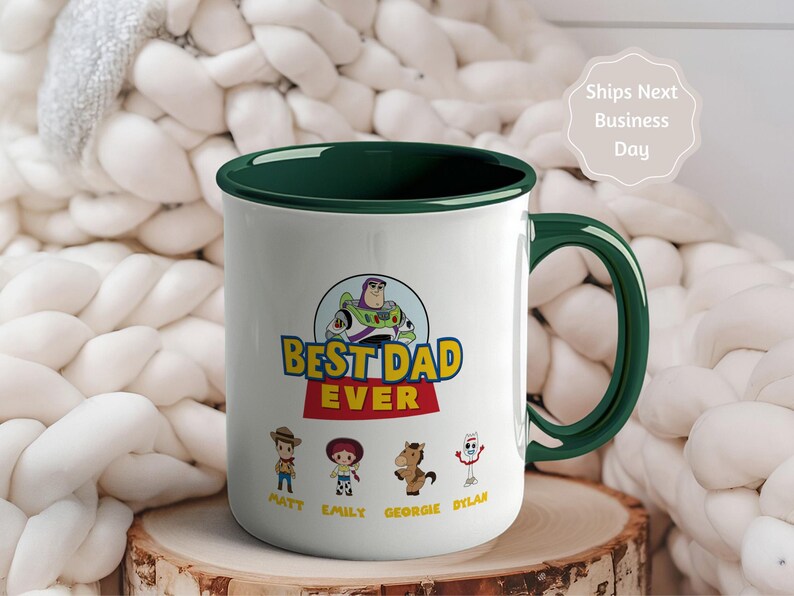 May include: A white ceramic mug with a dark green interior and handle. The front features a graphic of Buzz Lightyear above the text "BEST DAD EVER" in yellow and red. Below are four cartoon characters with the names Matt, Emily, Georgie, and Dylan.