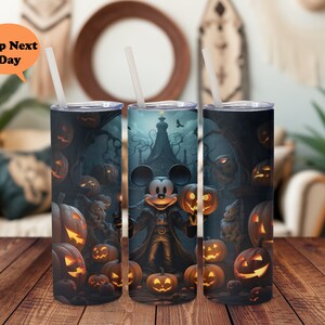 May include: A set of three stainless steel tumblers with a Halloween theme featuring Mickey Mouse dressed as a vampire. The tumblers are decorated with jack-o'-lanterns and other Halloween imagery.