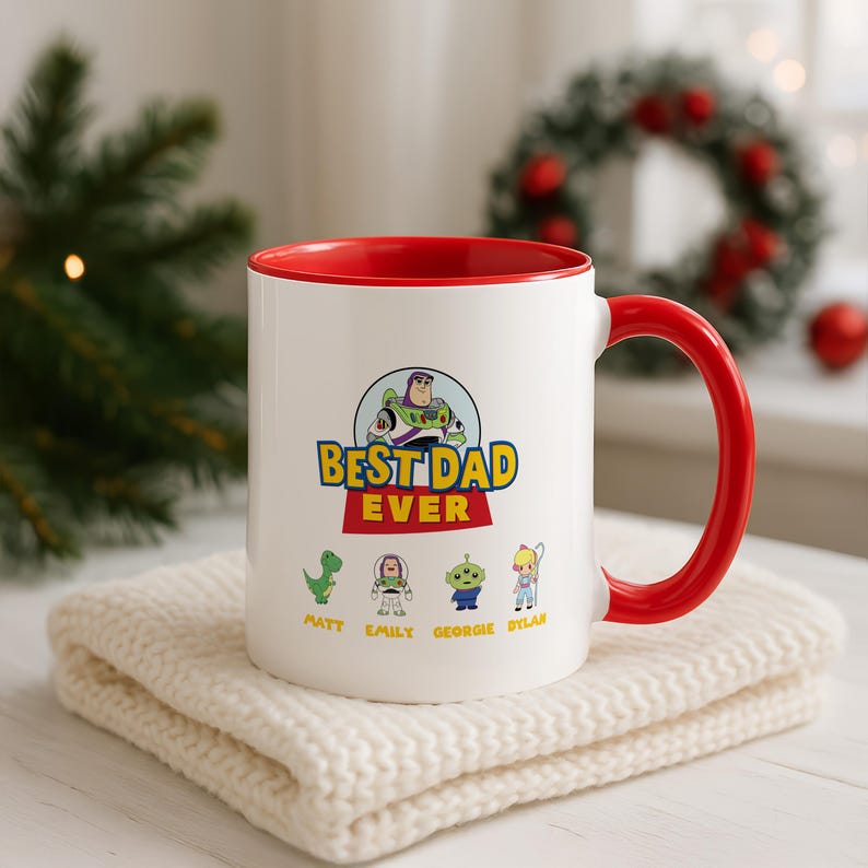 May include: A white ceramic mug with a bright red interior and handle. The front features a graphic of Buzz Lightyear above the text BEST DAD EVER, with smaller illustrations of Rex, Buzz, an alien, and Bo Peep, labeled Matt, Emily, Georgie, and Dylan.