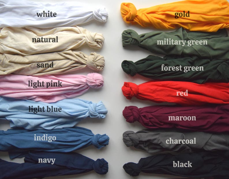 May include: A collection of folded fabric samples in various colors, including white, gold, military green, red, and black. Each sample is labeled with its color name, such as "white," "gold," and "red."