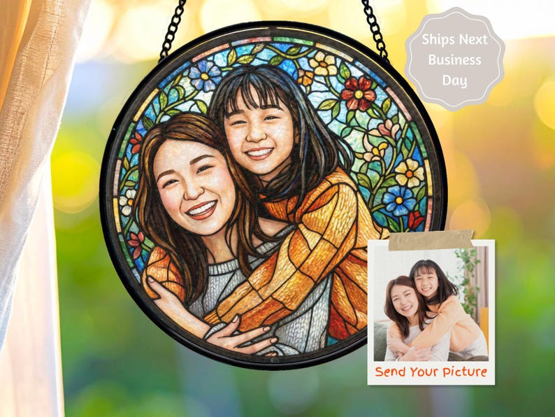 May include: Round stained glass art piece featuring a portrait of two smiling people, surrounded by a floral border. The artwork is framed in black and hangs from a chain. A small photo with the text "Send Your picture" is also included.