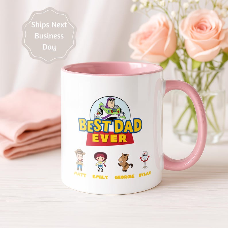 May include: A white ceramic mug with a pink interior and handle, featuring a graphic of Buzz Lightyear above the text BEST DAD EVER. Below are four cartoon characters with the names Matt, Emily, Georgie, and Dylan printed underneath them.