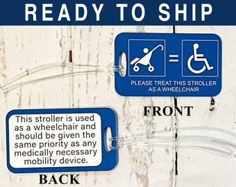 May include: Blue stroller tag with white text and graphics. The front reads "PLEASE TREAT THIS STROLLER AS A WHEELCHAIR" with a stroller equals wheelchair symbol. The back states the stroller should be given the same priority as a mobility device.