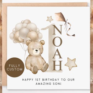 May include: A watercolor illustration of a brown teddy bear holding a bunch of balloons. The balloons are beige and brown. The illustration is on a white background with the text "Noah" in brown letters and the text "Happy 1st Birthday to our amazing son!" in brown letters.