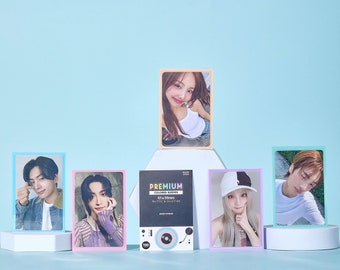 May include: Five photo cards with colorful borders, featuring different people. The cards are arranged in a row on a light blue background. The center card is a light blue and pink card with the text "PREMIUM COLORED SLEEVES 61 x 89mm No PVC & Acid Free" and a graphic of a record player.