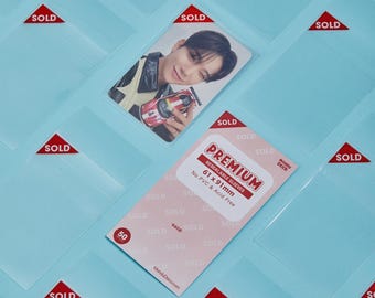 May include: A pack of 50 clear resealable sleeves for photo cards. The sleeves are 61 x 91 mm and are acid free and PVC free. The sleeves are labeled "Premium Resealable Sleeves".